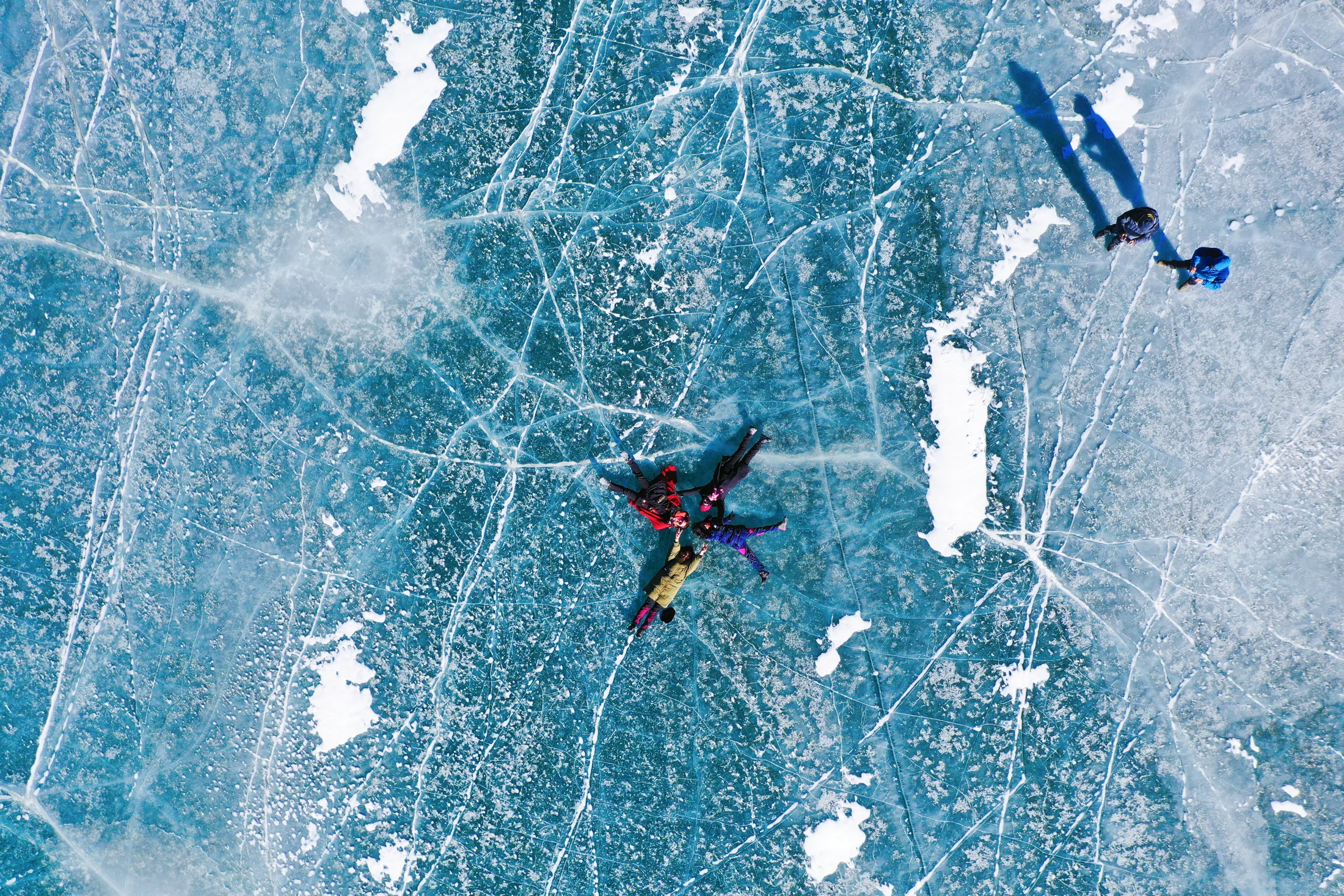 Family on blue ice, seen from above
